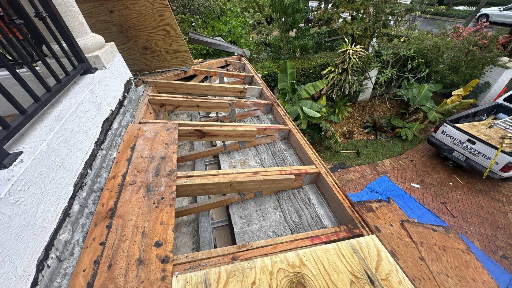 Exposed roof framing during a Boca Raton roof repair