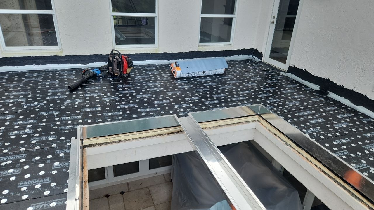 Roofing work in progress beside the skylight opening