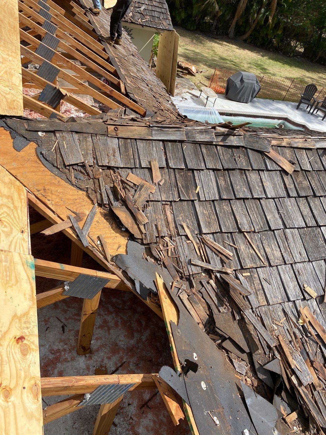 Damaged wood shake roof removed from the deck