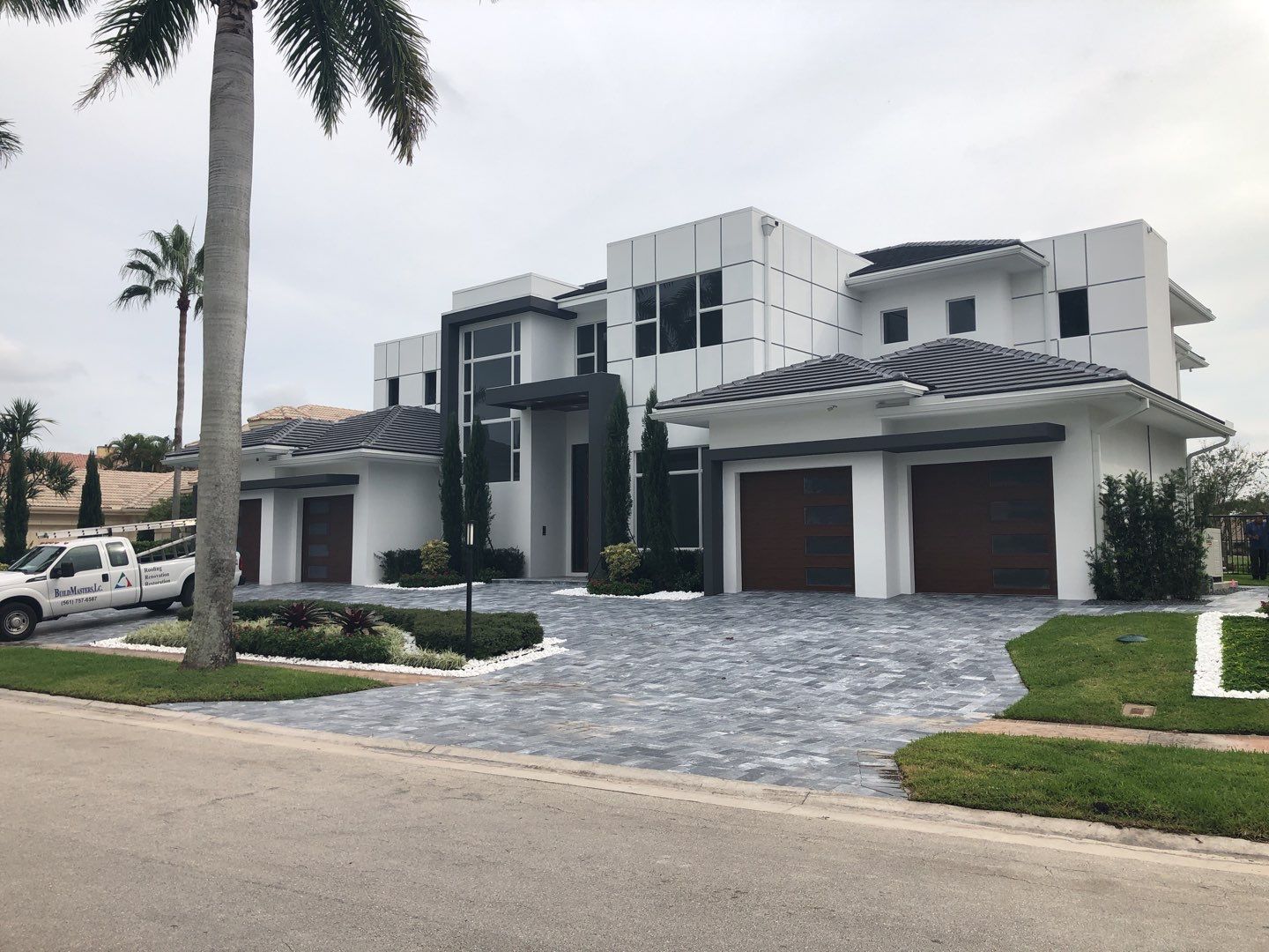 Completed Boca Raton new construction home with gray tile and flat roof areas