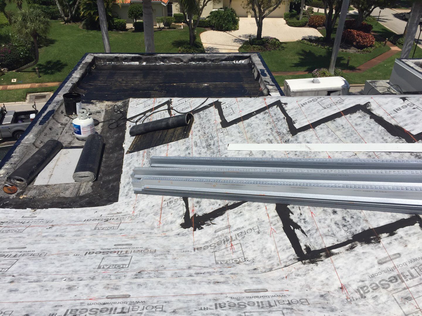 Flat roofing installation during construction of the Boca Raton home