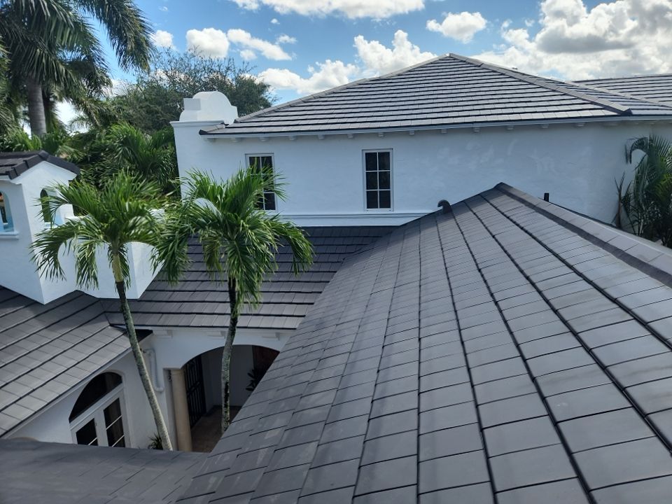 Completed slate-look clay tile roof on a white Delray Beach home