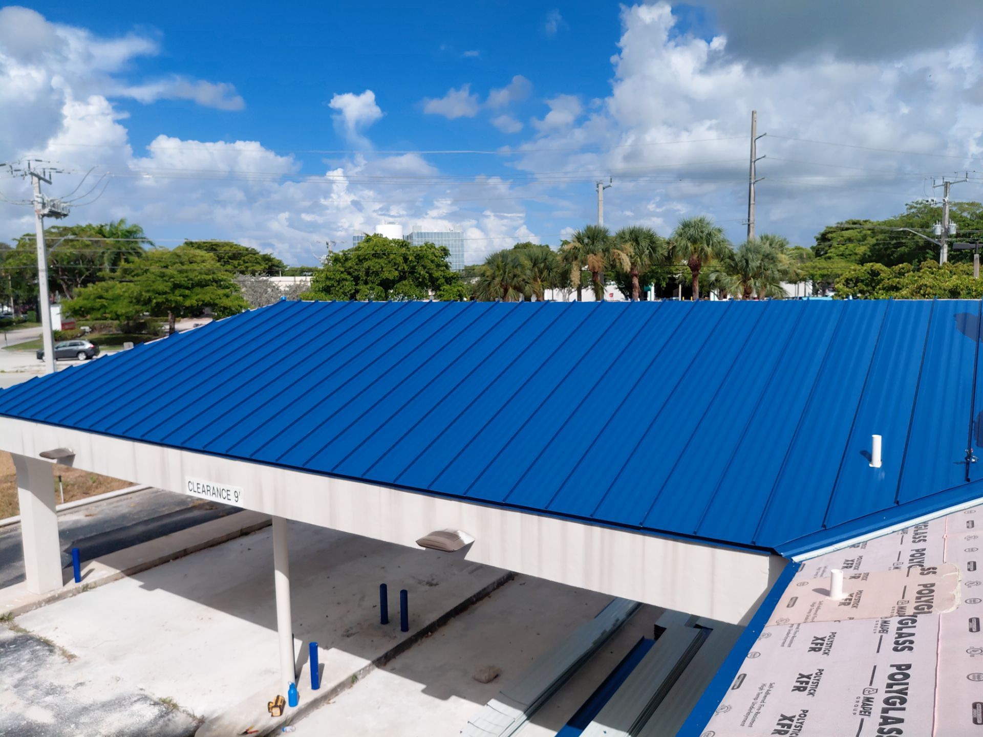 Blue standing-seam metal roof panels on the commercial building in Delray Beach