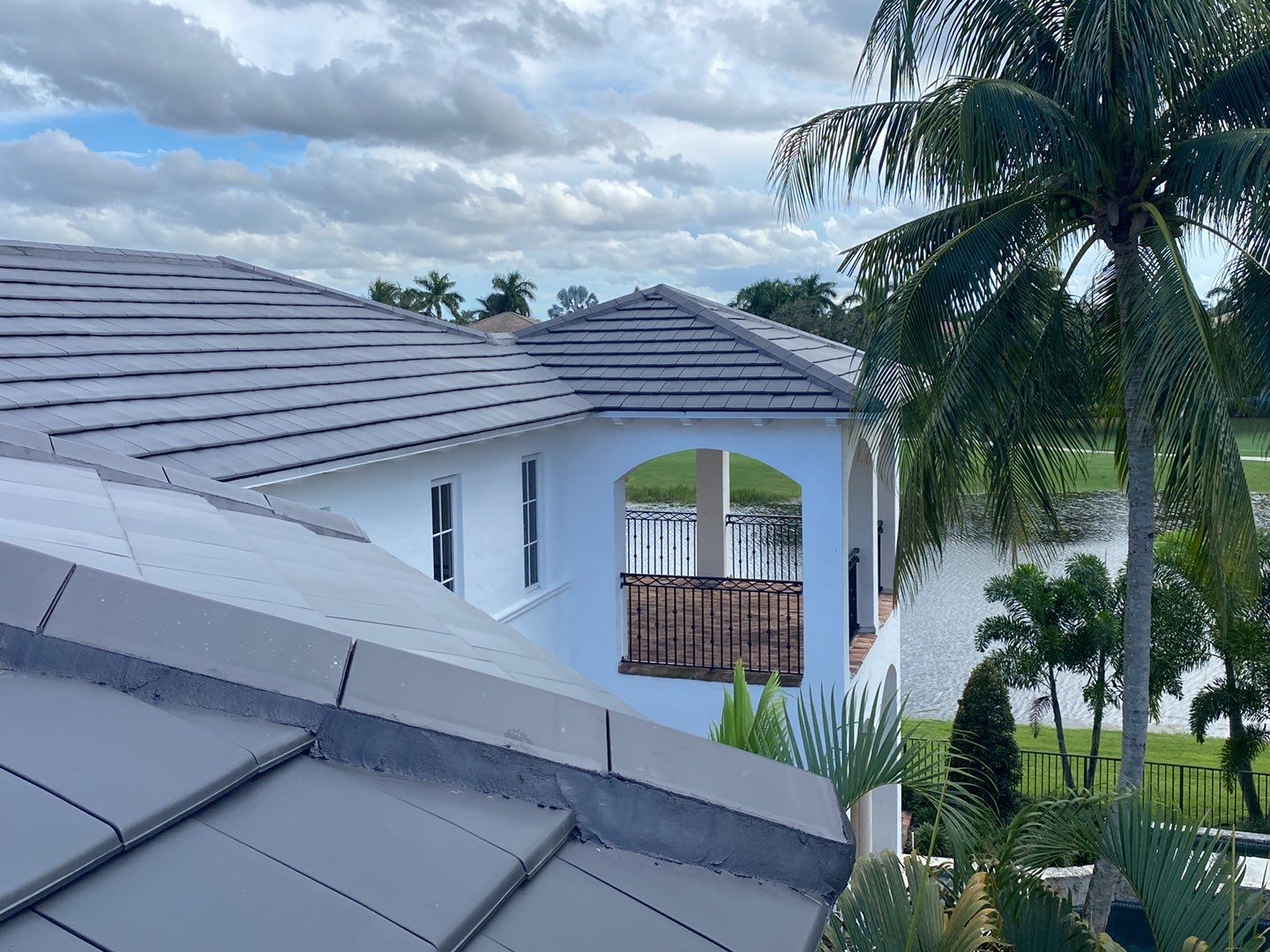 Finished slate-look clay tile roof beside the home's upper story