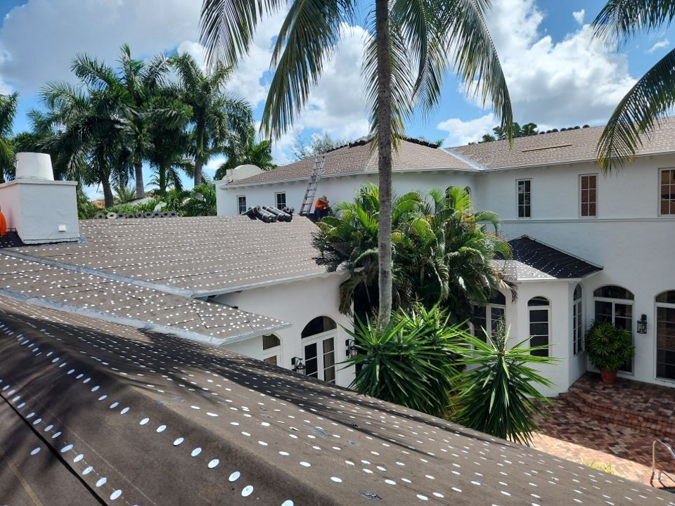 Roof underlayment installation across intersecting slopes at the Delray Beach home